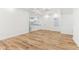 Open-concept living room with wood flooring, white walls, and seamless flow into the modern kitchen at 324 W 7Th St, Anderson, IN 46016