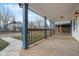 Inviting porch with wood flooring, charming railing, and stylish lighting fixtures create a cozy outdoor space at 324 W 7Th St, Anderson, IN 46016