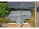 Aerial view of the house featuring a new gray roof, landscaping, and a backyard deck at 325 E 10Th St, Indianapolis, IN 46202