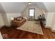 Finished attic with sloped ceilings, hardwood floors, and a cozy seating area at 325 E 10Th St, Indianapolis, IN 46202