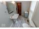 Bathroom featuring pedestal sink, tiled floor, and traditional fixtures at 325 E 10Th St, Indianapolis, IN 46202