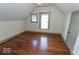 Bedroom featuring hardwood floors, neutral paint, natural light, and sloped ceilings at 325 E 10Th St, Indianapolis, IN 46202