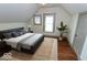 Cozy bedroom with hardwood floors, natural light from two windows, and a comfortable queen bed at 325 E 10Th St, Indianapolis, IN 46202