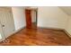 Bedroom featuring wood floors, neutral paint, and a view into the hallway at 325 E 10Th St, Indianapolis, IN 46202