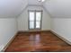Bedroom featuring hardwood floors, neutral paint, natural light, and sloped ceilings at 325 E 10Th St, Indianapolis, IN 46202