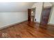 Bedroom featuring wood floors, neutral paint, and access to two closets at 325 E 10Th St, Indianapolis, IN 46202