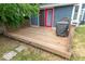 Exterior deck featuring wood flooring, wooden railing, and red door at 325 E 10Th St, Indianapolis, IN 46202