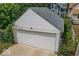 View of a white two-car garage with a paved driveway at 325 E 10Th St, Indianapolis, IN 46202