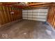 Interior view of empty garage with concrete floor and open wooden beams at 325 E 10Th St, Indianapolis, IN 46202