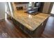 Close-up of the kitchen island with granite countertop and cooktop at 325 E 10Th St, Indianapolis, IN 46202