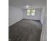 Spacious bedroom with gray carpet, bright white walls, a ceiling light, and two large windows at 3614 N Capitol Ave, Indianapolis, IN 46208