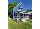 Charming blue two-story home with a cozy front porch and awning, perfect for relaxation at 3614 N Capitol Ave, Indianapolis, IN 46208
