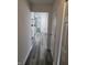 Bright hallway featuring modern gray floors leading to a well-lit kitchen and open living space at 3614 N Capitol Ave, Indianapolis, IN 46208