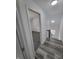 Hallway with gray vinyl floors leads to a bedroom with gray carpet through a bright white doorway at 3614 N Capitol Ave, Indianapolis, IN 46208