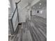 Spacious living area featuring sleek gray floors, recessed lighting, and an open layout to the kitchen at 3614 N Capitol Ave, Indianapolis, IN 46208