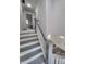 Stylish staircase with gray treads and white risers leading to the upper level, bathed in natural light at 3614 N Capitol Ave, Indianapolis, IN 46208