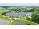 An aerial view of a clubhouse and pool area surrounded by trees and a golf course at 3989 Birkdale Dr, Carmel, IN 46033