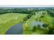 Aerial view of lush golf course with ponds and mature trees in a suburban setting at 3989 Birkdale Dr, Carmel, IN 46033