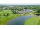 Scenic aerial view of golf course and clubhouse with water feature in a landscaped setting at 3989 Birkdale Dr, Carmel, IN 46033