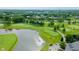 Aerial view showcasing a golf course and lake, highlighting the area's recreational opportunities at 3989 Birkdale Dr, Carmel, IN 46033