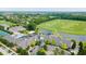 Aerial view featuring the clubhouse, pool, and meticulously maintained golf course at 3989 Birkdale Dr, Carmel, IN 46033