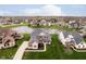 Aerial view of a stunning home with a backyard pond and other homes in a picturesque neighborhood at 3989 Birkdale Dr, Carmel, IN 46033