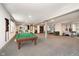 Finished basement featuring a billiards table, performance area, and flexible space for recreation at 3989 Birkdale Dr, Carmel, IN 46033