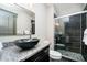 Bathroom featuring granite countertops, a glass bowl sink, and a tiled shower at 3989 Birkdale Dr, Carmel, IN 46033