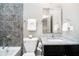 Modern bathroom with gray tile, dark vanity, and stylish fixtures at 3989 Birkdale Dr, Carmel, IN 46033