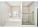 Serene bathroom featuring a soaking tub, glass-enclosed shower, and tile accents for a spa-like experience at 3989 Birkdale Dr, Carmel, IN 46033