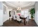 Elegant dining room featuring a modern chandelier, decorative trim, and dark wood floors at 3989 Birkdale Dr, Carmel, IN 46033