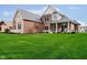 Beautiful brick and stone home with a well-manicured lawn, and an inviting front porch at 3989 Birkdale Dr, Carmel, IN 46033