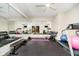 Home gym with mirrored walls, fitness equipment, and rubber flooring for a perfect workout space at 3989 Birkdale Dr, Carmel, IN 46033