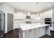 Contemporary kitchen featuring a marble island, sleek stainless steel appliances, and modern pendant lighting at 3989 Birkdale Dr, Carmel, IN 46033