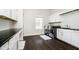 Convenient laundry room featuring a washer, dryer, storage cabinets, and countertop workspace at 3989 Birkdale Dr, Carmel, IN 46033