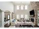 Spacious living room with a stone fireplace, soaring ceilings, and abundant natural light at 3989 Birkdale Dr, Carmel, IN 46033