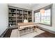 Bright home office with custom built-in shelving and a large window at 3989 Birkdale Dr, Carmel, IN 46033