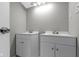 Modern bathroom features double sinks and vanities with grey walls at 4140 Melbourne Rd, Indianapolis, IN 46228