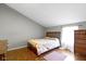Comfortable bedroom with a sloped ceiling features wood floors and natural light at 4140 Melbourne Rd, Indianapolis, IN 46228