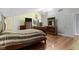 Bright bedroom boasts hardwood floors, a stylish ceiling fixture, and a sleigh bed at 4140 Melbourne Rd, Indianapolis, IN 46228