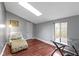 Bright bedroom features hardwood floors and a window with natural light at 4140 Melbourne Rd, Indianapolis, IN 46228