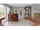 Dining room with marble floors, wooden bar and china cabinet at 4140 Melbourne Rd, Indianapolis, IN 46228
