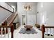 Elegant foyer featuring high ceilings, staircase, tile flooring and natural light at 4140 Melbourne Rd, Indianapolis, IN 46228
