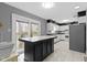 Bright kitchen with island, white cabinets, and stainless steel appliances at 4140 Melbourne Rd, Indianapolis, IN 46228