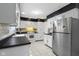 Bright kitchen with white cabinets, stainless steel appliances and black countertops at 4140 Melbourne Rd, Indianapolis, IN 46228