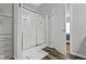 Modern bathroom featuring a glass-enclosed shower, storage cabinet, and a doorway leading to another room at 4221 Millersville Rd, Indianapolis, IN 46205