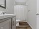 Bathroom with modern vanity, framed mirror, and shower with curtain at 4221 Millersville Rd, Indianapolis, IN 46205
