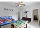 This bedroom features a ceiling fan, foosball table, and adjacent doors at 4221 Millersville Rd, Indianapolis, IN 46205