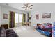 Bright bedroom featuring fan, futon, foosball table, and superhero-themed decor at 4221 Millersville Rd, Indianapolis, IN 46205
