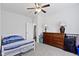 Bedroom with ceiling fan, natural light, dresser, and neutral carpet at 4221 Millersville Rd, Indianapolis, IN 46205